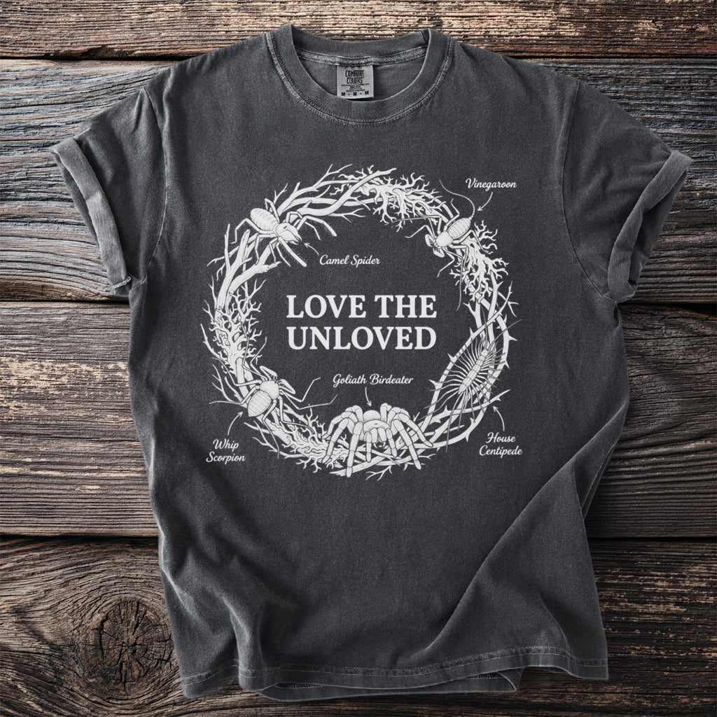 Dark t-shirt with "LOVE THE UNLOVED" and illustrated insects in a wreath.