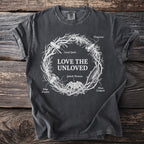 Dark t-shirt with "LOVE THE UNLOVED" and illustrated insects in a wreath.