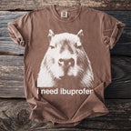 Brown t-shirt with white capybara graphic and text "i need ibuprofen".