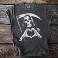 Grim reaper making a heart shape with skeleton hands on a charcoal t-shirt.