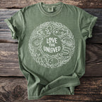 Green t-shirt with white circular print of sea creatures and text "Love the Unloved."