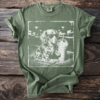 Green t-shirt with a distressed print of a dachshund wearing sunglasses next to a drink.