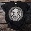 Black t-shirt with a white circular design of a tentacled creature and tribal patterns.