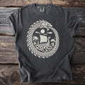 Dark t-shirt with white dragon biting tail, ship on waves, and sun.
