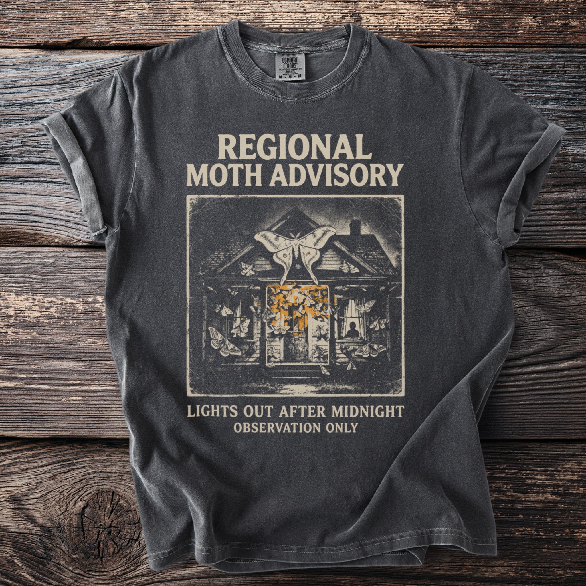 Dark t-shirt with "REGIONAL MOTH ADVISORY" and a house surrounded by moths.