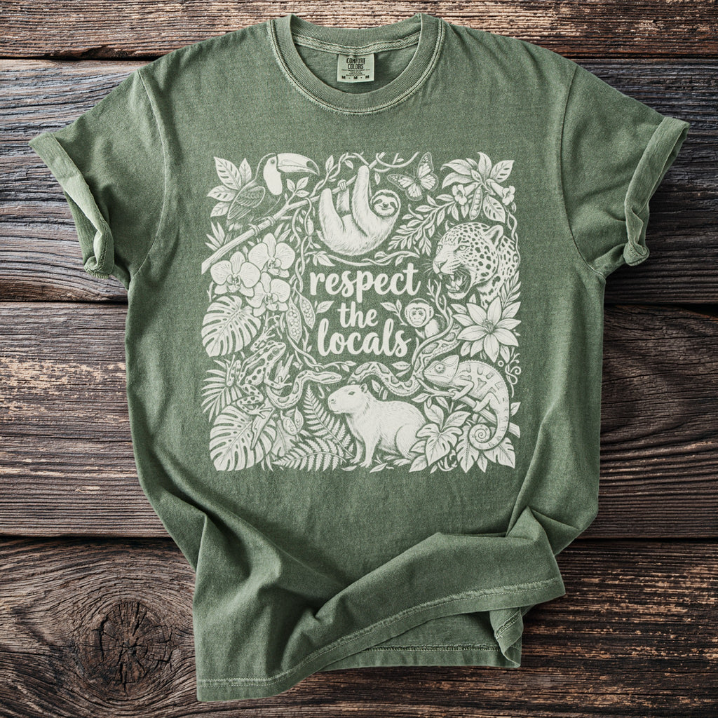 Green t-shirt with white graphic of jungle animals and text "respect the locals".