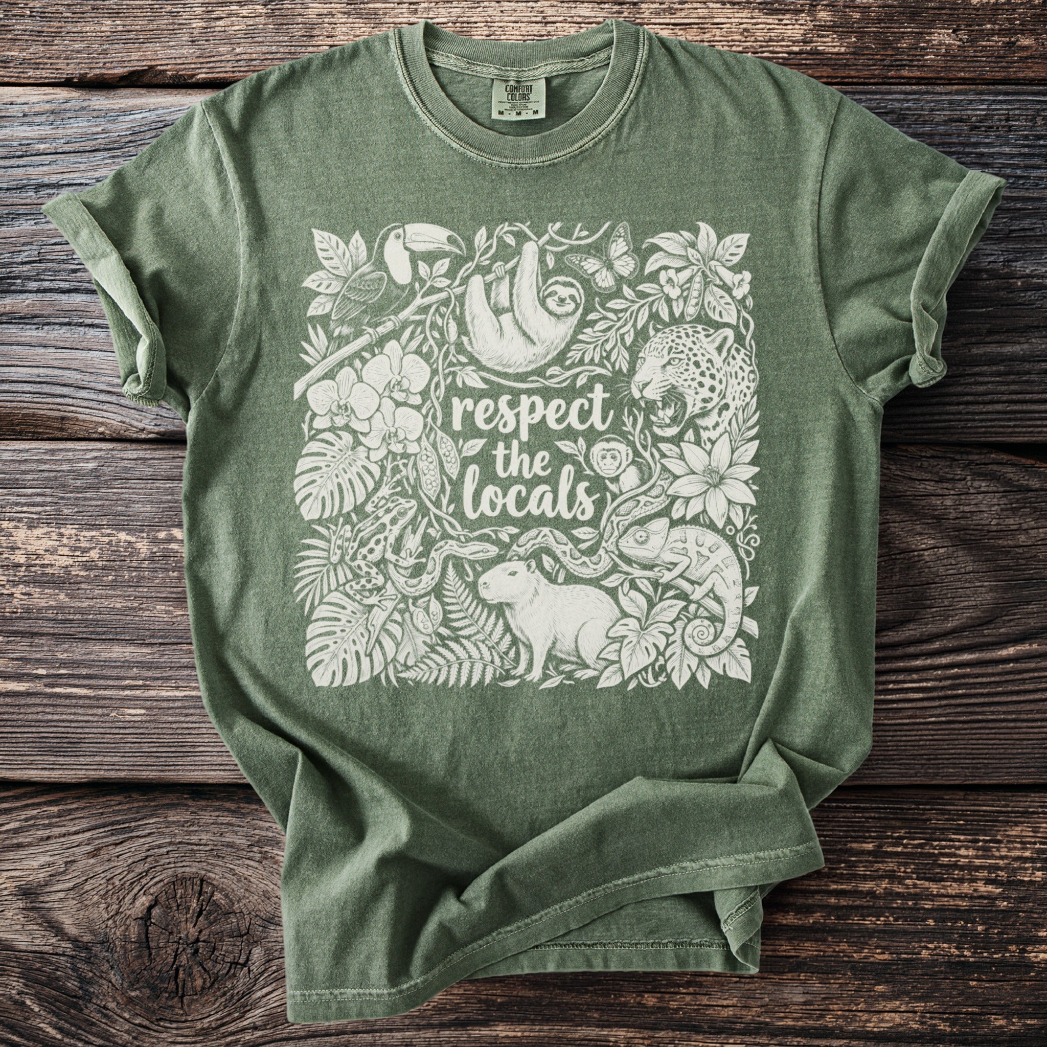 Green t-shirt with white graphic of jungle animals and text "respect the locals".