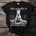 Black t-shirt with a stylized image of a fallen horse and text "this actually is my first rode".