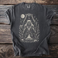 Dark t-shirt with a graphic of a bear warrior, axe, spear, moon, and runes.