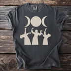 Dark t-shirt with a triple moon goddess symbol and dancing figures.