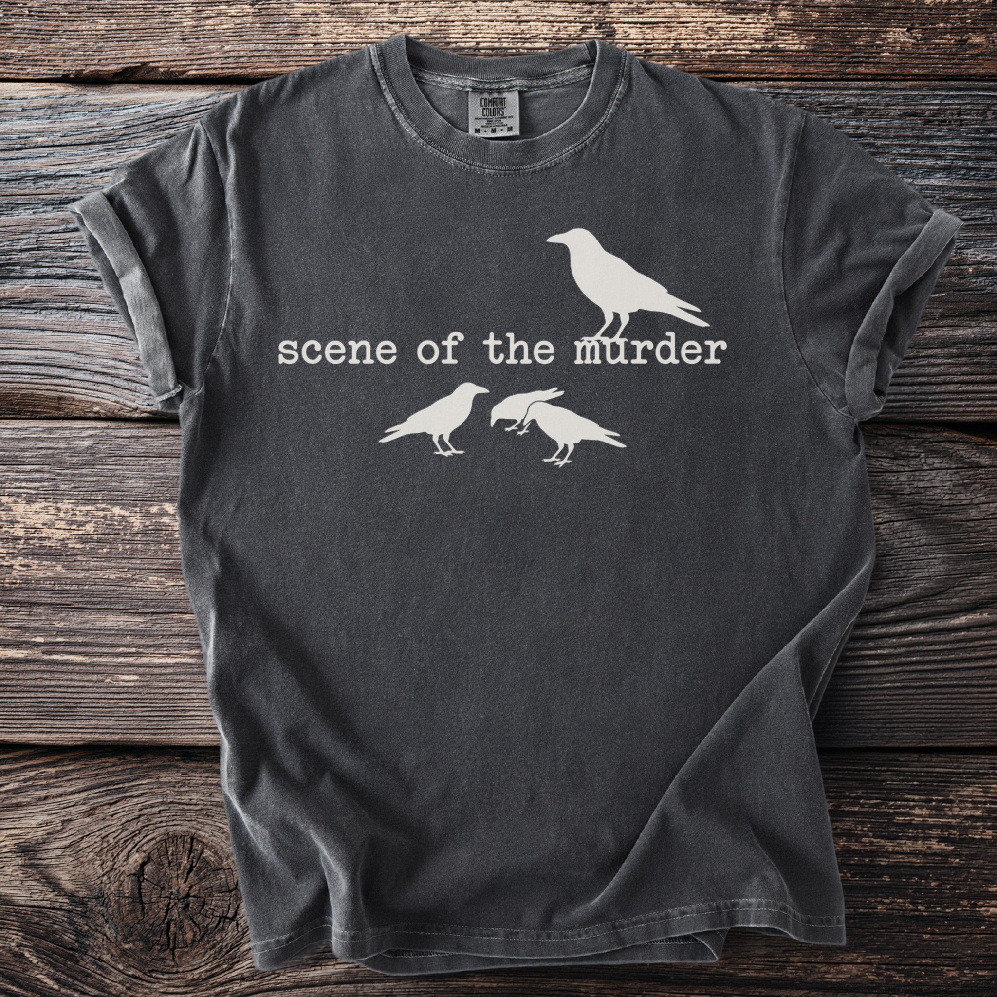 Dark grey t-shirt with white graphic of a single crow above text and three crows below.