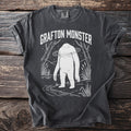 Dark gray t-shirt with "Grafton Monster" text and white Bigfoot graphic.