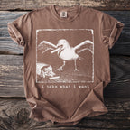 Brown t-shirt with graphic of a seagull stealing french fries and text "i take what i want".
