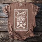 Brown t-shirt with white graphic of skull, plants, poison bottle, snake, and bones.