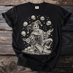 Skeleton jester surrounded by skulls and stars on a black t-shirt.