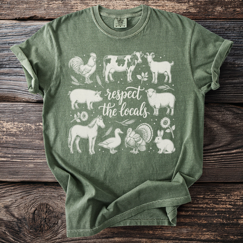 Green t-shirt with sketch-style farm animals and text "respect the locals".