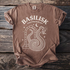 Brown t-shirt with white graphic of a coiled serpent wearing a crown and arch.