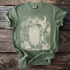 Green t-shirt with wizard, wolves, eagles, trees, moon, and runes graphic.