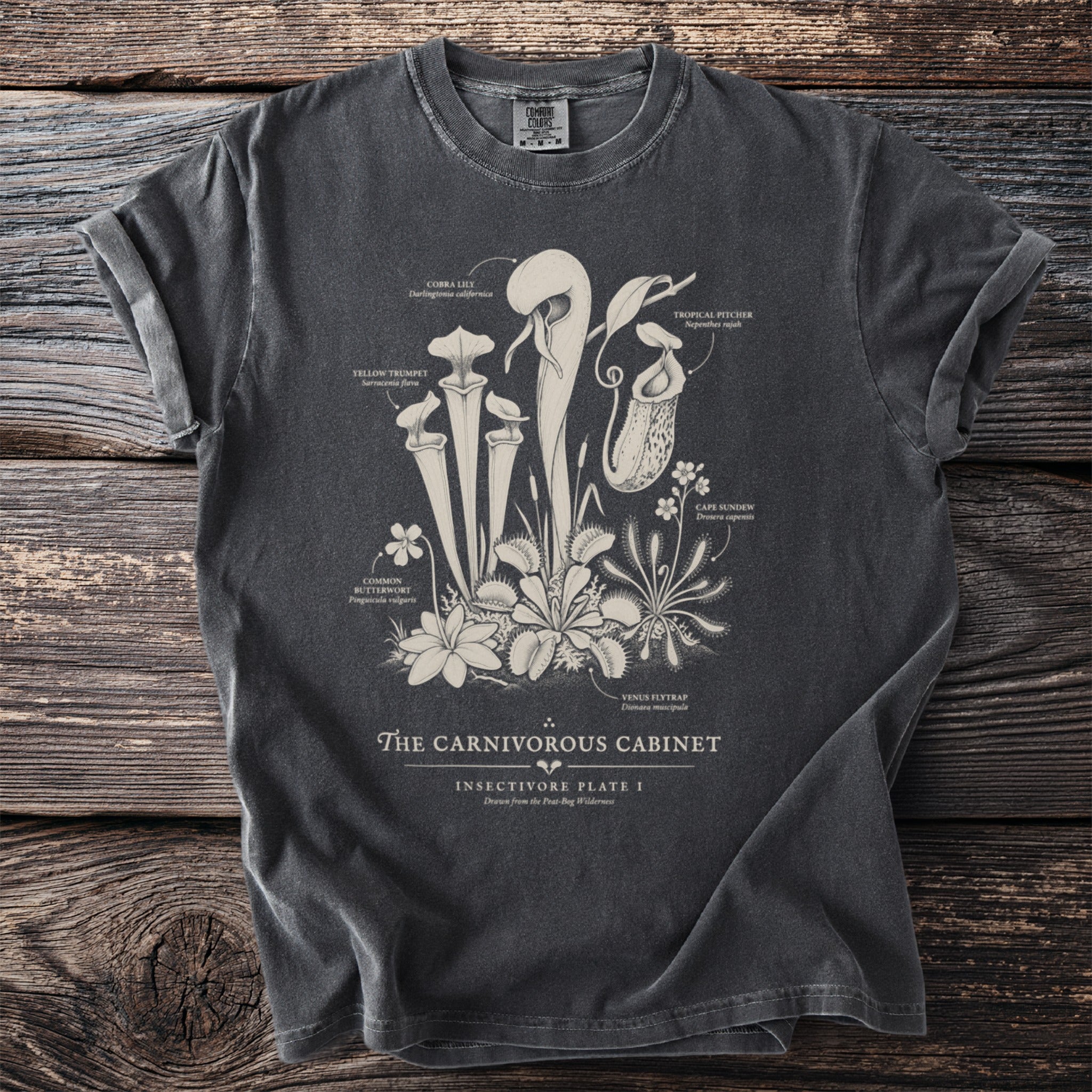 Grey t-shirt featuring botanical illustrations of carnivorous plants and the text "The Carnivorous Cabinet".