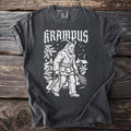 Dark t-shirt with white Krampus graphic, holding chains and birch branches.