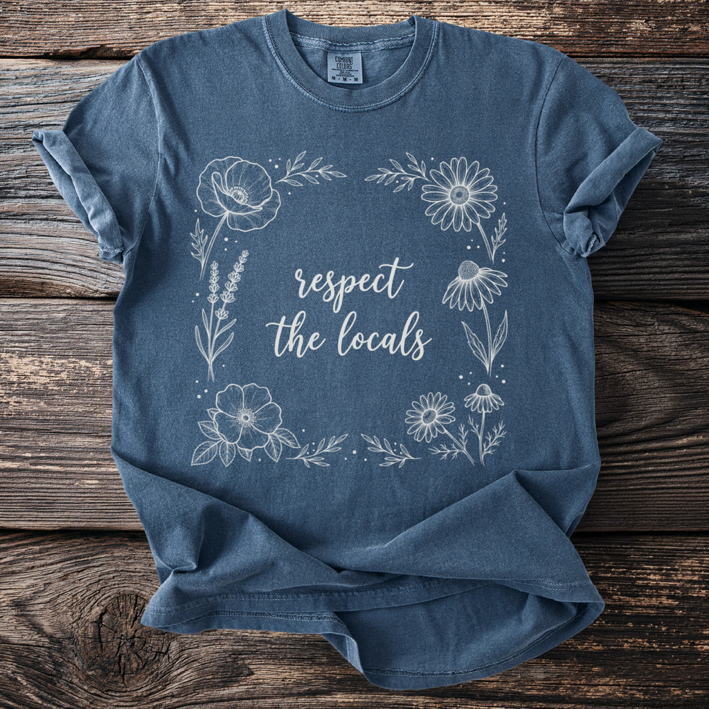 Blue t-shirt with floral border and "respect the locals" text