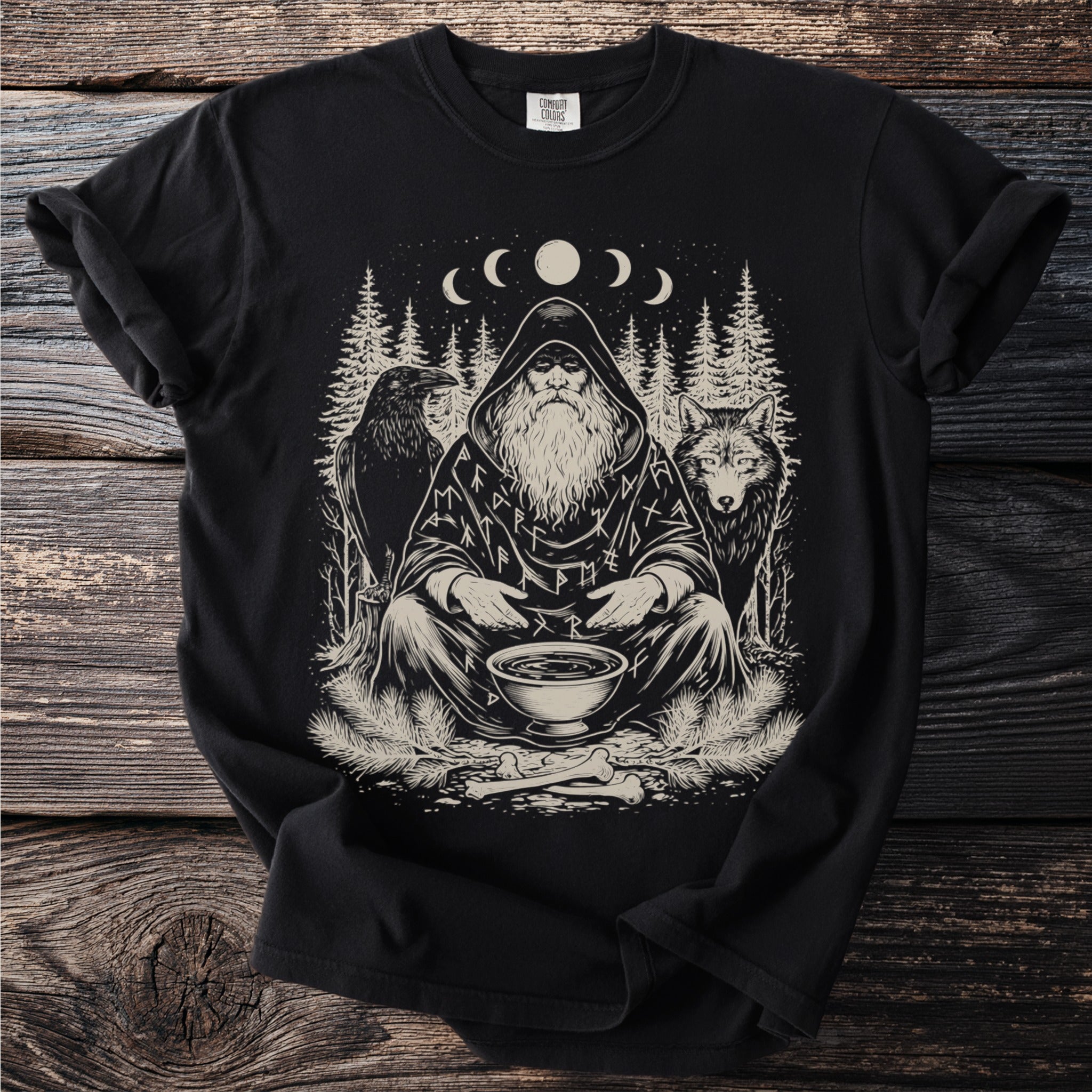 Black t-shirt with print of a hooded figure, raven, wolf, trees, and runes.