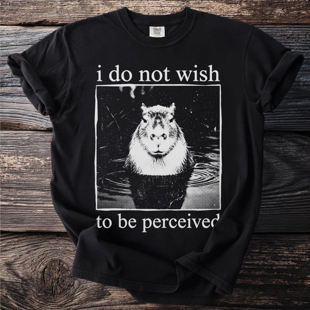 Black t-shirt with a capybara in water and text "i do not wish to be perceived."