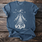 Blue t-shirt featuring a white outline of a person with foxglove and lily of the valley plants.