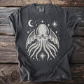 Dark gray t-shirt with a white tentacled creature design and celestial motifs.