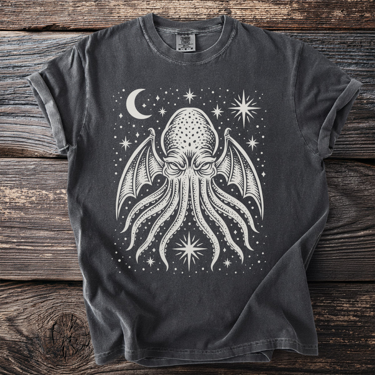Dark gray t-shirt with a white tentacled creature design and celestial motifs.