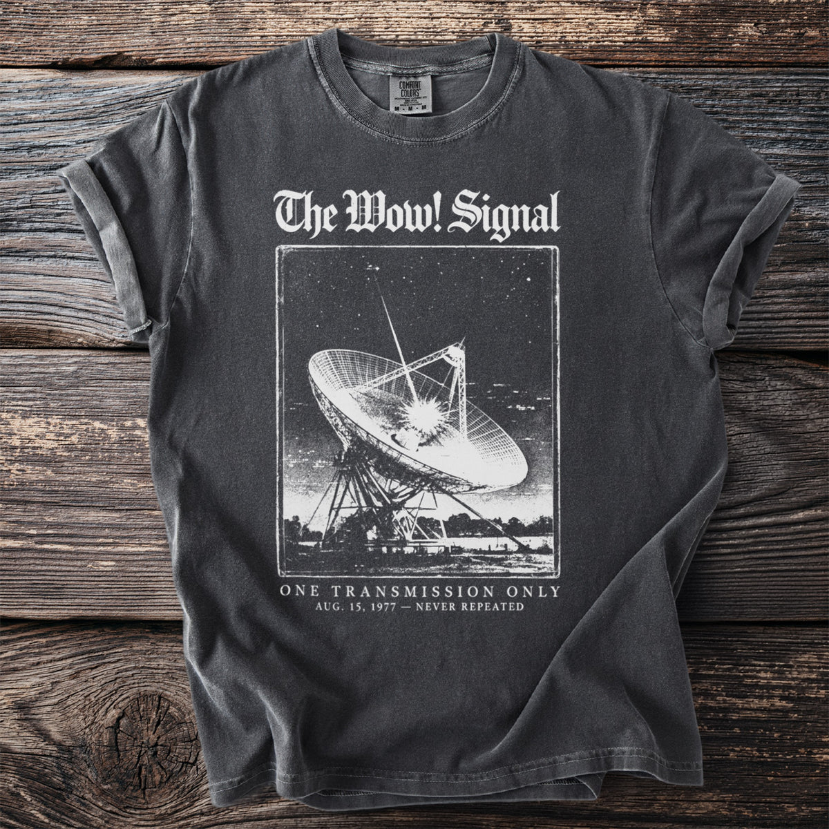 Dark t-shirt with "The Wow! Signal" and a radio telescope graphic.