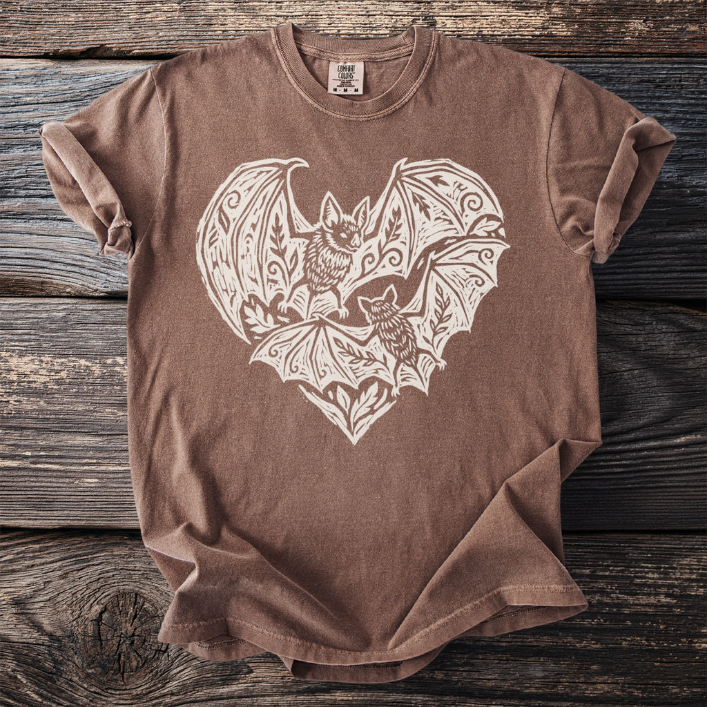 Brown t-shirt with white graphic of two bats within a heart design.