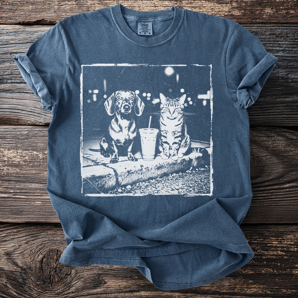 T-shirt with a vintage-style print of a dachshund and tabby cat with a drink.
