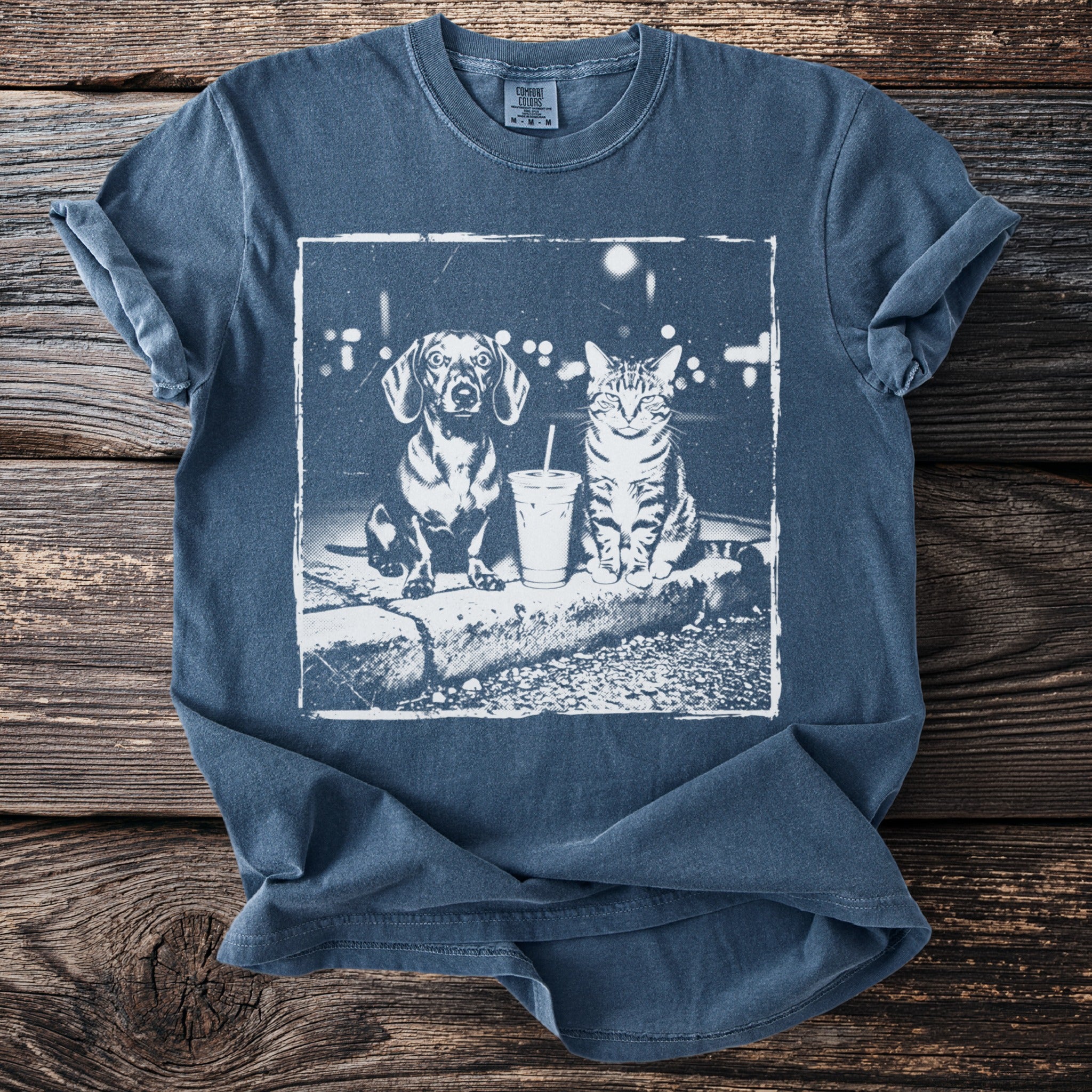 T-shirt with a vintage-style print of a dachshund and tabby cat with a drink.
