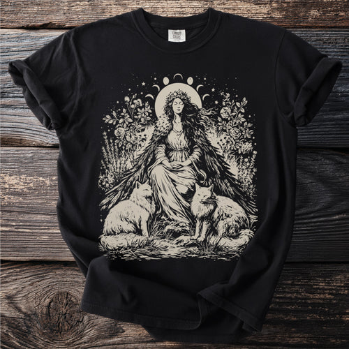 Black t-shirt with a cream graphic of a seated woman, two foxes, and celestial elements.
