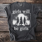 Dark t-shirt with white text "girls will be girls" and silhouette of witches.