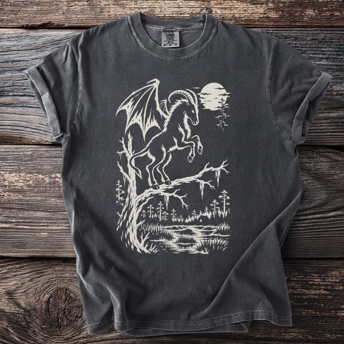 Dark grey t-shirt with a cream-colored winged creature on a tree branch.