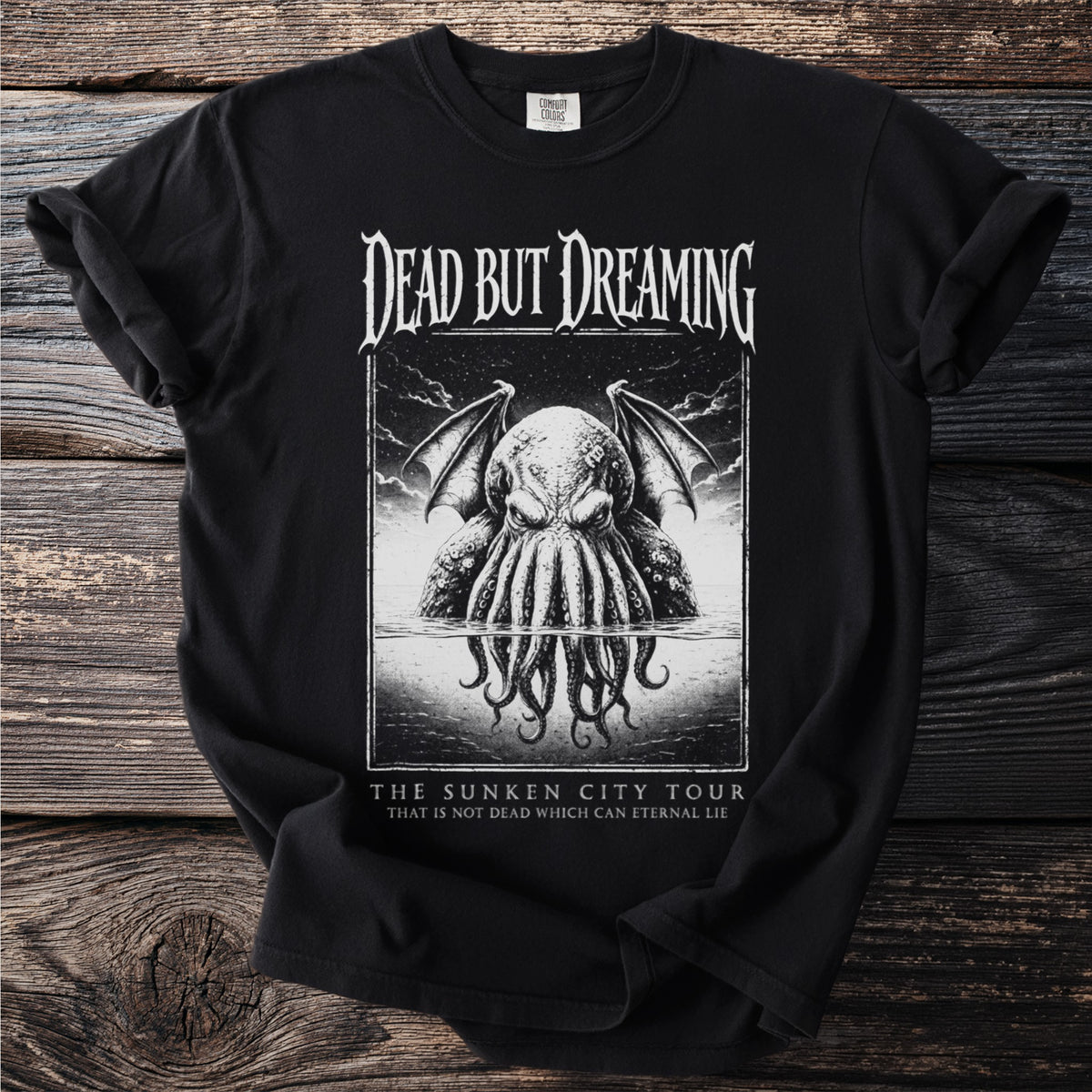 Black t-shirt with "Dead But Dreaming" and tentacled creature graphic, "The Sunken City Tour" text.