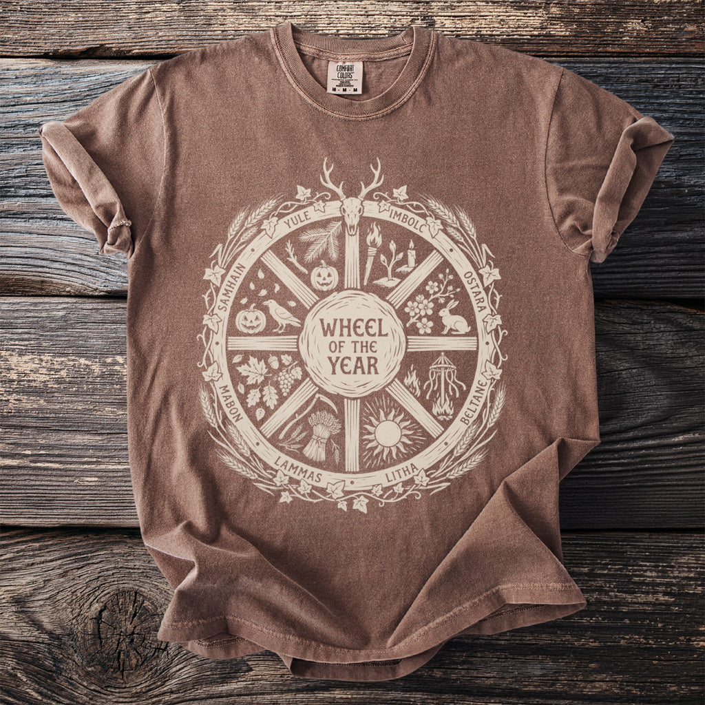 Brown t-shirt with a cream "Wheel of the Year" graphic featuring seasonal holidays and symbols.