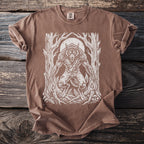 Brown t-shirt with a white linocut-style werewolf and moon graphic in a forest.