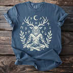 Blue t-shirt with a beige graphic of a horned figure surrounded by runes and branches.