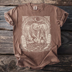 Brown t-shirt with a Viking drawing of a wolf and warrior with runes on stones.