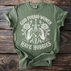 Green t-shirt with white text and graphic of hands, dagger, heart, and roses.