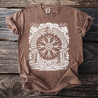 Brown t-shirt with white Viking helm, Norse symbol, trees, axes, and stones graphic.