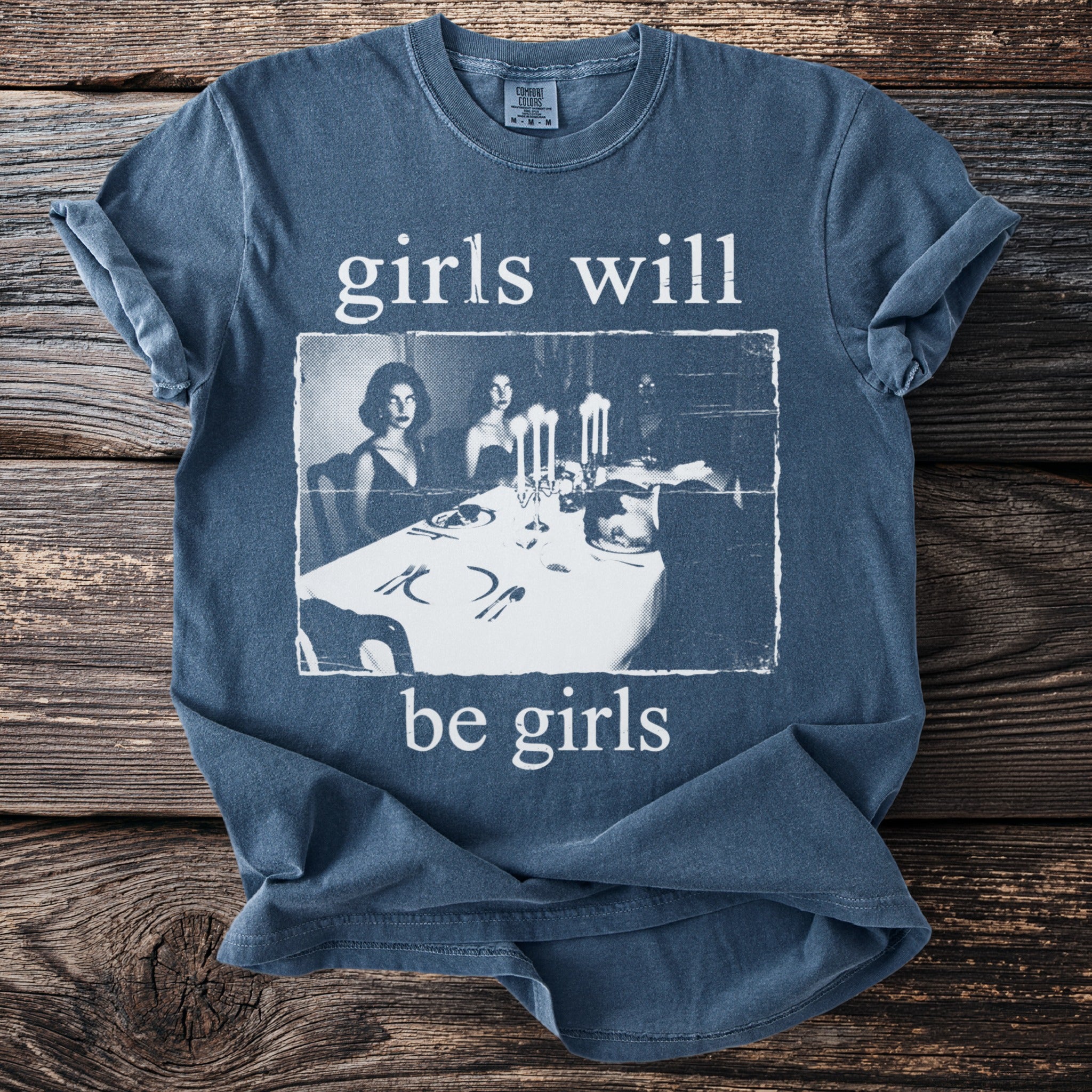 Blue t-shirt with "girls will be girls" text and a vintage image of women at a table.