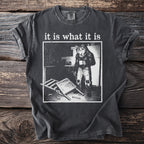 T-shirt with "it is what it is" text and a wolf in human clothes holding a mug.