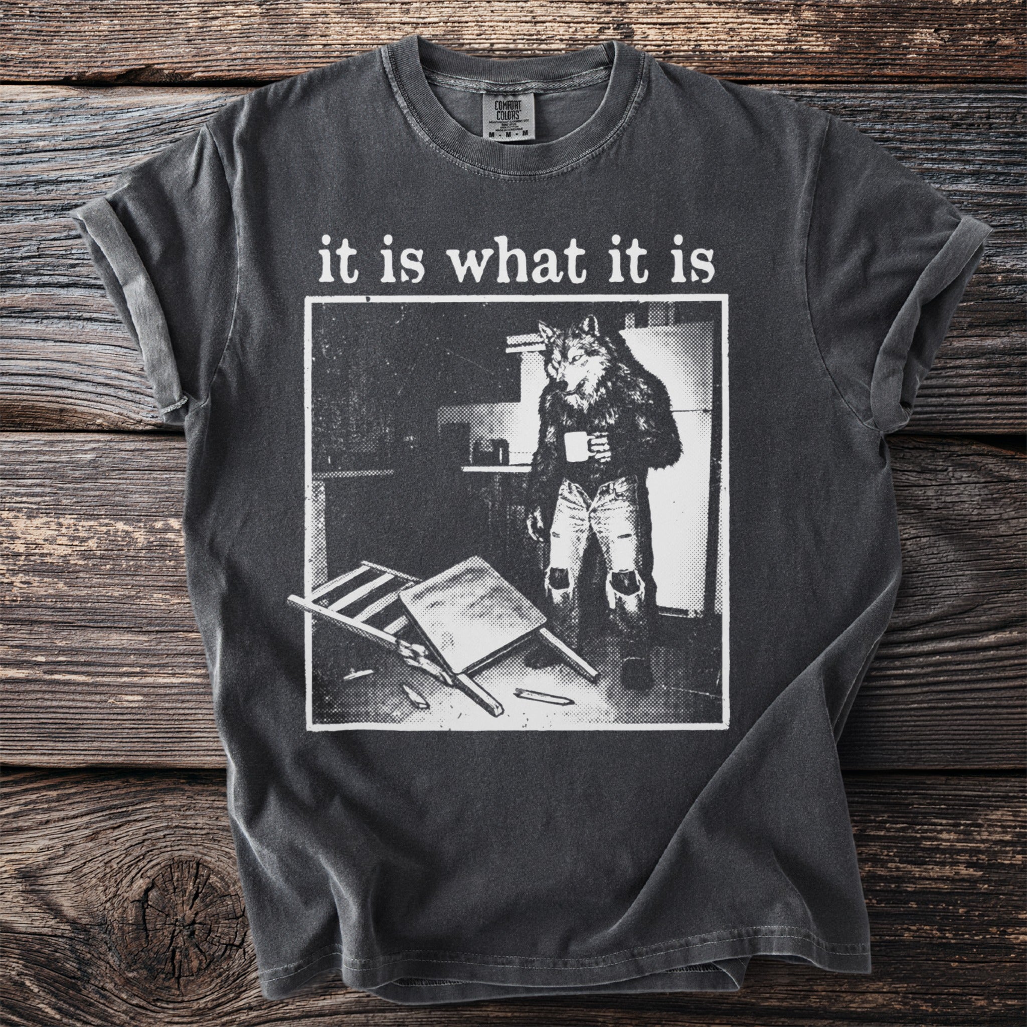 T-shirt with "it is what it is" text and a wolf in human clothes holding a mug.