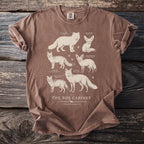 Brown t-shirt with illustrations of six different fox species and text "The Fox Cabinet".