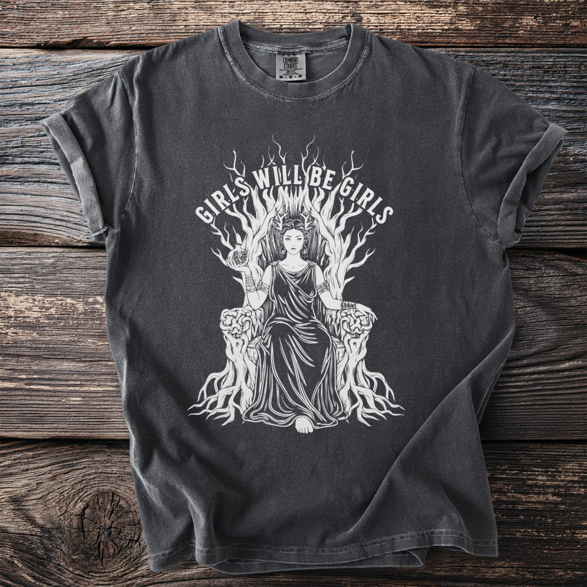 Dark grey t-shirt with white graphic of a seated woman on a throne and text "GIRLS WILL BE GIRLS".