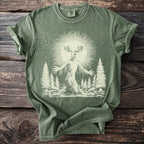 Green t-shirt featuring a creature with antlers in a forest scene with a sunburst.